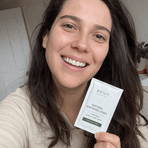 Customer selfie smiling with whitening strip sachet
